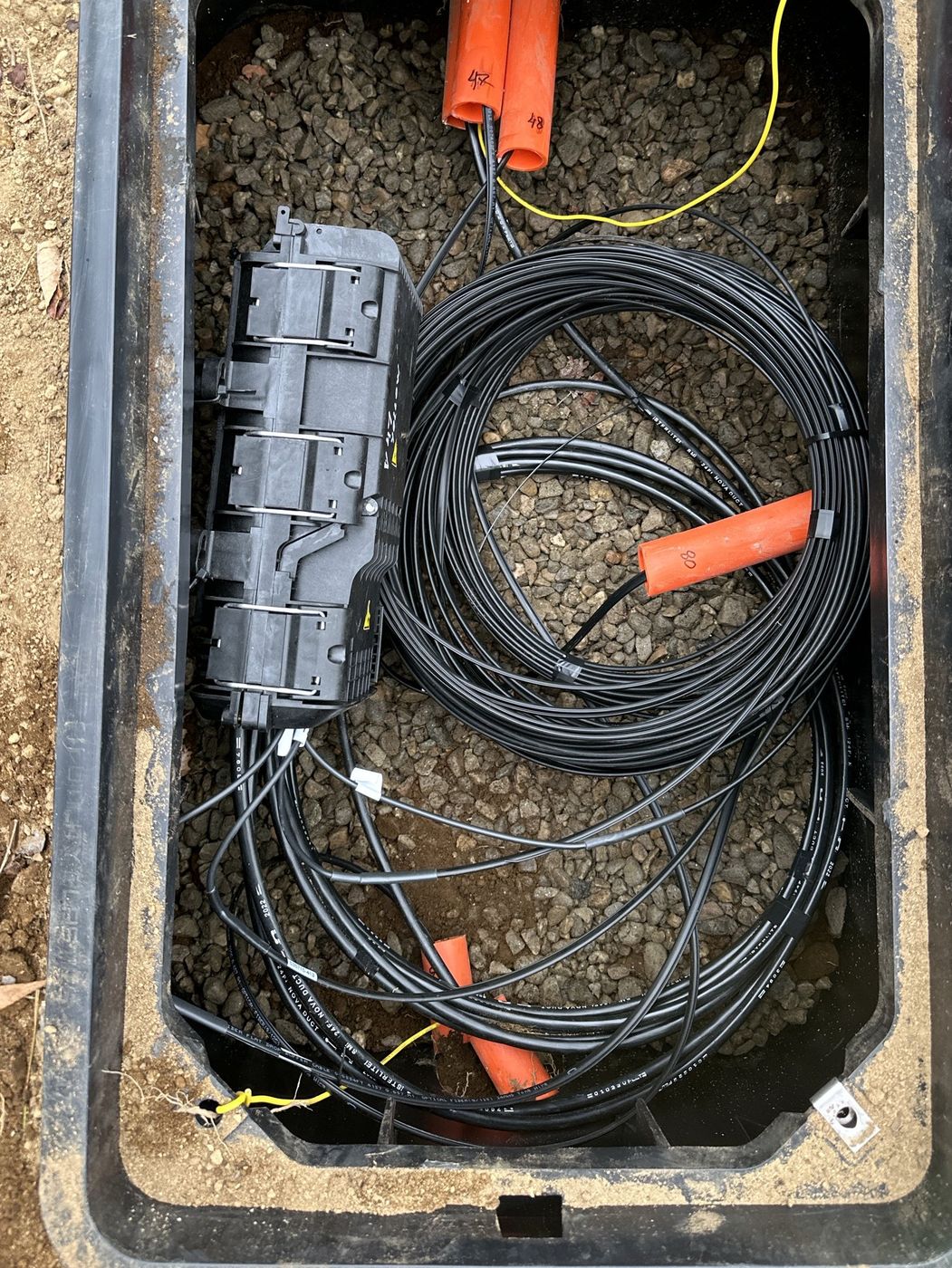 Underground handhole with fiber closure and slack loops